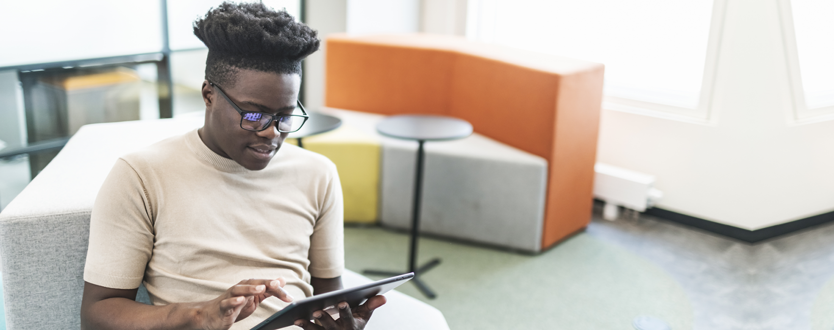 One Black businessman working at new business from modern office using digital tablet